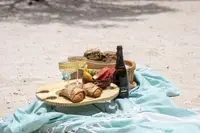 Beach picnic-to-go setup on the sand with snacks and drinks in Aruba