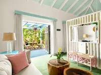 Coco Deluxe Casita living area at Boardwalk Boutique Hotel Aruba with sofa seating and indoor-outdoor terrace view.
