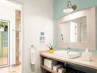 Coco Deluxe Casita bathroom at Boardwalk Boutique Hotel Aruba with sink vanity and walk-in shower.