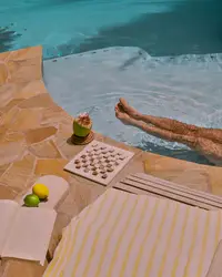 Relaxing at the Boardwalk Boutique Hotel Aruba pool with fresh coconut