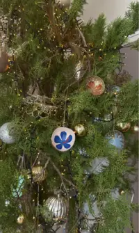Close-up of the festive Christmas tree with warm lights and handmade Aruba-inspired ornaments at Boardwalk Boutique Hotel Aruba.