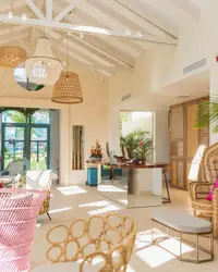 ight, tropical-style lobby at Boardwalk Boutique Hotel Aruba with plants, seating area, and airy high ceiling.